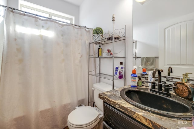 full bathroom featuring toilet, shower / bath combo, and vanity