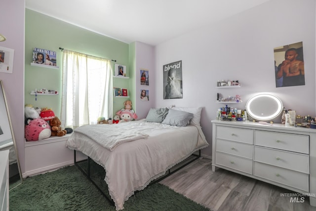 bedroom with wood finished floors
