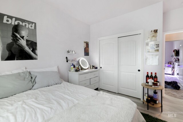 bedroom with a closet and light hardwood / wood-style flooring