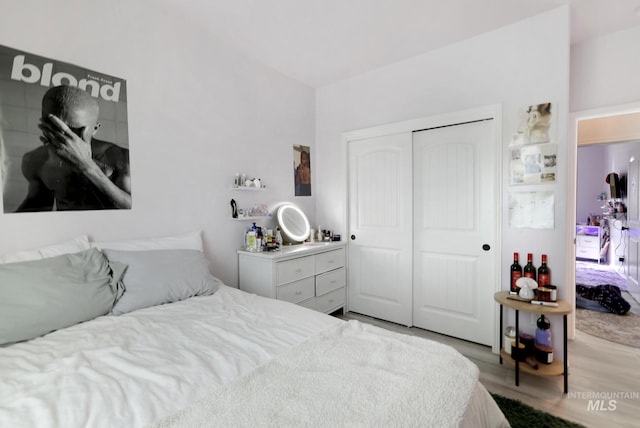 bedroom with a closet and wood finished floors