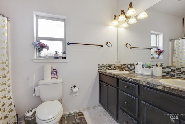 bathroom with a shower with curtain, vanity, backsplash, and toilet