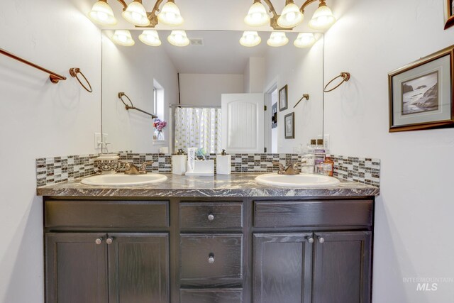 bathroom featuring vanity, tasteful backsplash, and a shower with shower curtain