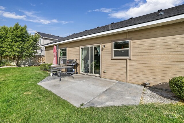 rear view of house with a yard and a patio