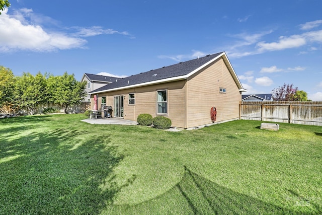back of property featuring a fenced backyard, a lawn, and a patio