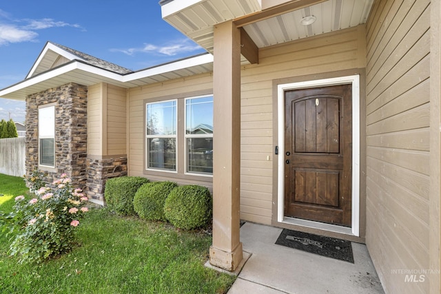 view of exterior entry featuring stone siding