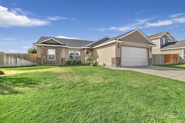 ranch-style home with a front lawn and a garage