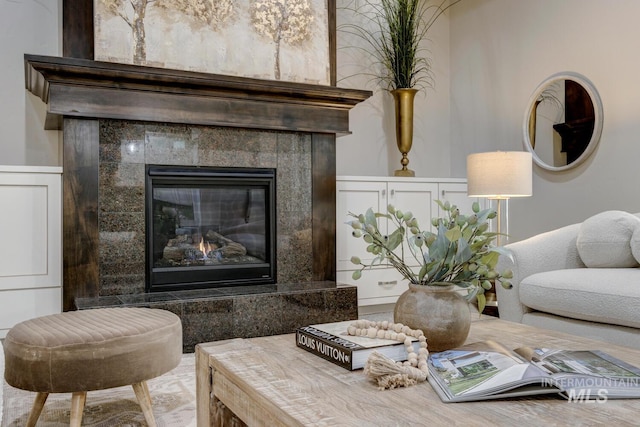 sitting room featuring a tiled fireplace