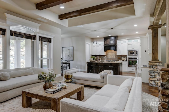 living room featuring decorative columns and light wood-type flooring