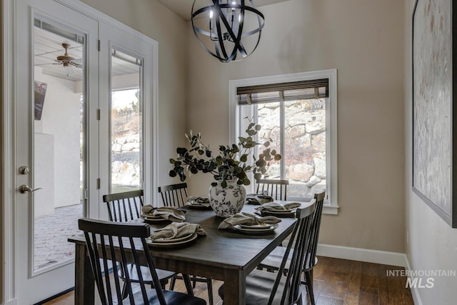 dining room featuring dark wood-type flooring, a chandelier, and a healthy amount of sunlight