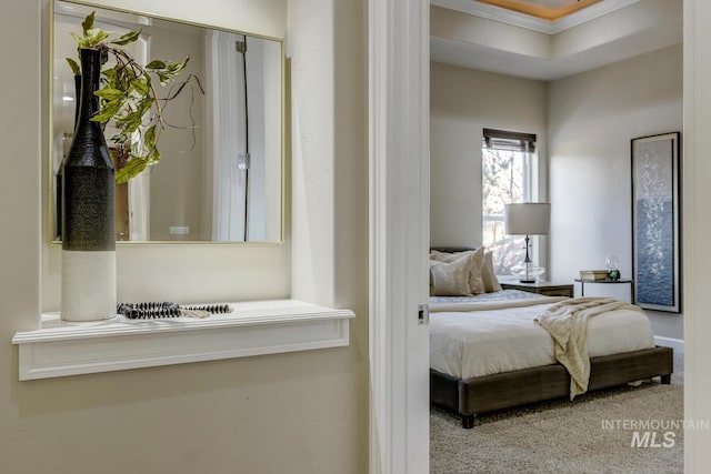 carpeted bedroom with ornamental molding