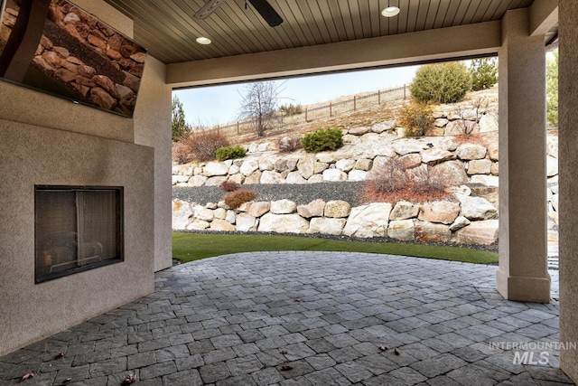 view of patio featuring ceiling fan