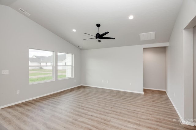 spare room featuring lofted ceiling, ceiling fan, and light hardwood / wood-style flooring