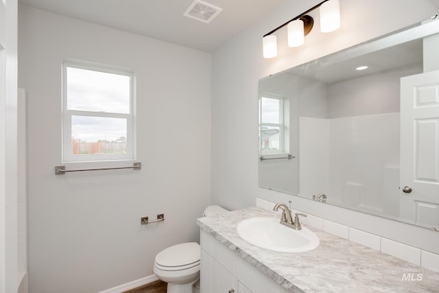 bathroom featuring vanity and toilet