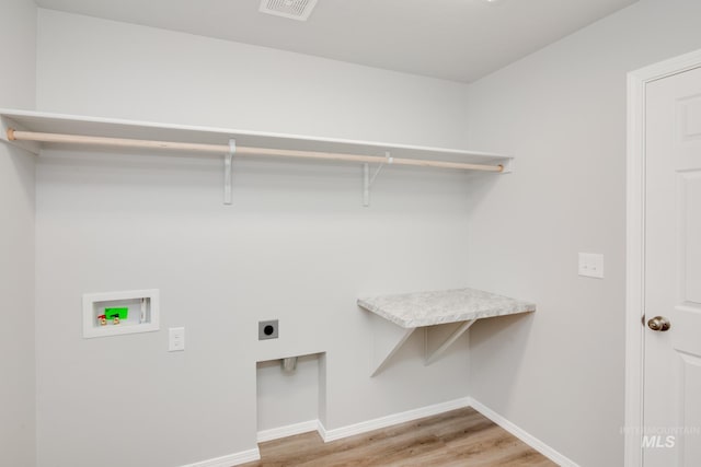 clothes washing area with washer hookup, hardwood / wood-style flooring, and hookup for an electric dryer