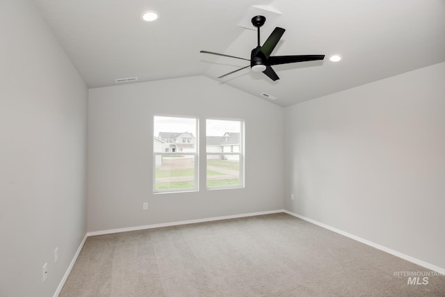 empty room featuring ceiling fan, lofted ceiling, and carpet floors