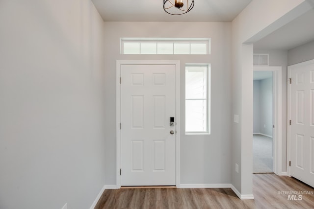 foyer entrance with light hardwood / wood-style floors