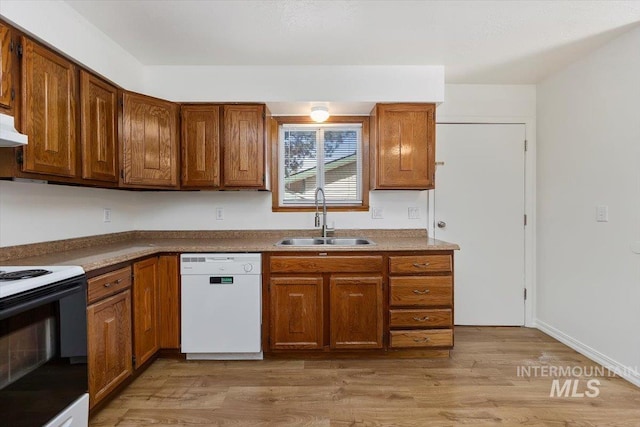 kitchen featuring brown cabinetry, light wood finished floors, electric range, a sink, and dishwasher