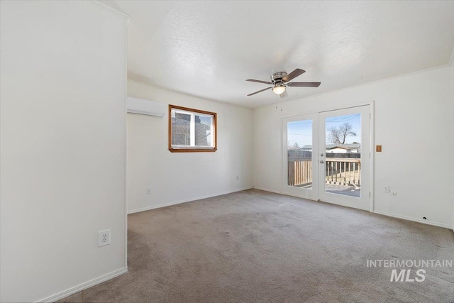 unfurnished room with a wall unit AC, a ceiling fan, baseboards, a textured ceiling, and carpet flooring