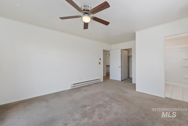 unfurnished bedroom with baseboards, carpet floors, baseboard heating, and ornamental molding