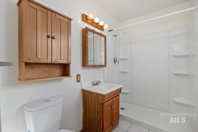 full bathroom with toilet, a stall shower, and vanity