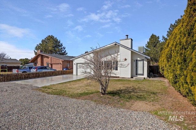 view of front of home with entry steps, concrete driveway, central AC unit, a chimney, and a garage