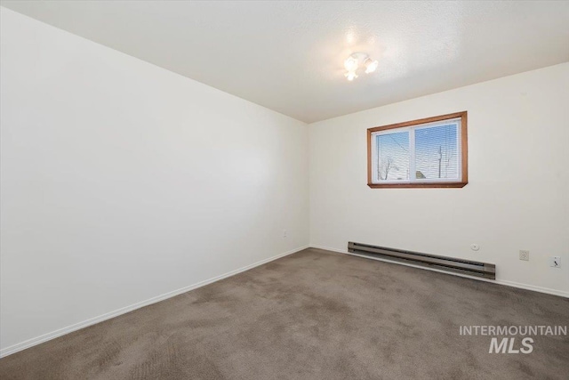 unfurnished room with baseboard heating, baseboards, and carpet