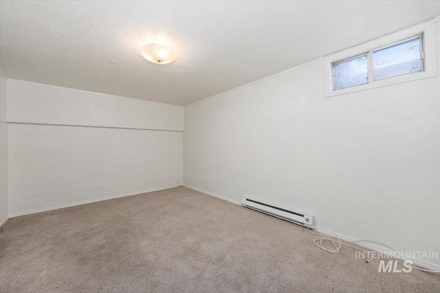 spare room featuring a textured ceiling, carpet, baseboards, baseboard heating, and a textured wall