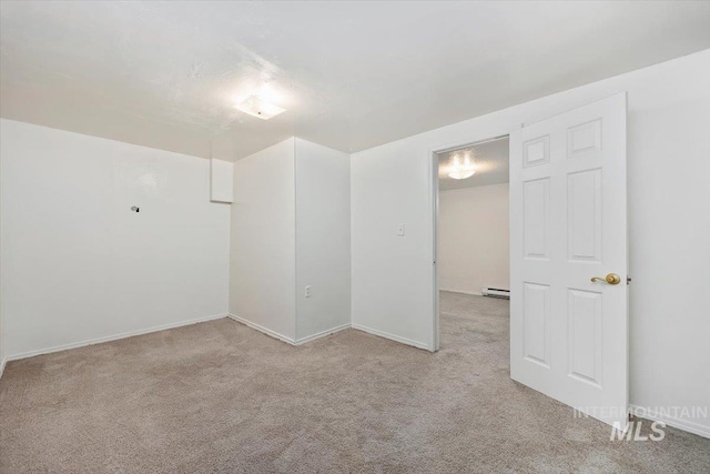 empty room featuring carpet floors and baseboard heating