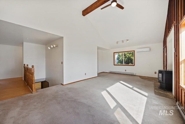 unfurnished living room featuring beamed ceiling, an AC wall unit, a wood stove, high vaulted ceiling, and a baseboard radiator