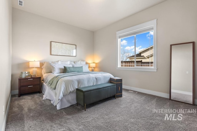 carpeted bedroom featuring visible vents and baseboards