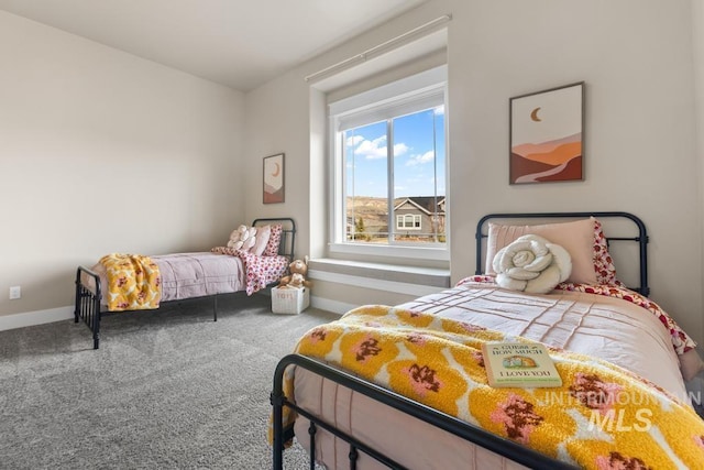 carpeted bedroom featuring baseboards