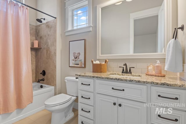 bathroom featuring vanity, toilet, and shower / bathtub combination with curtain