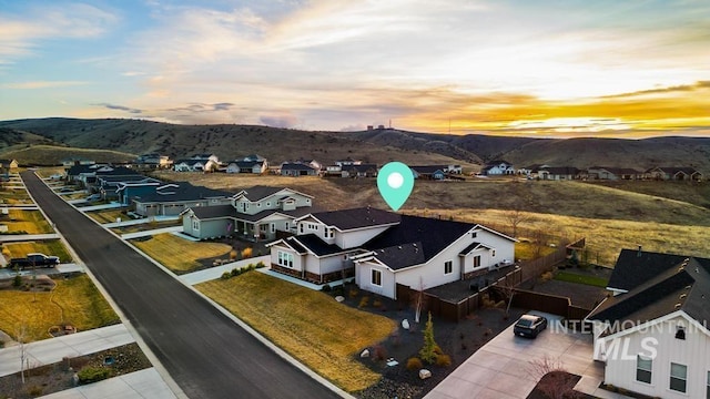 aerial view at dusk with a mountain view and a residential view