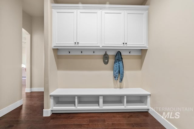 mudroom featuring dark wood-style floors and baseboards