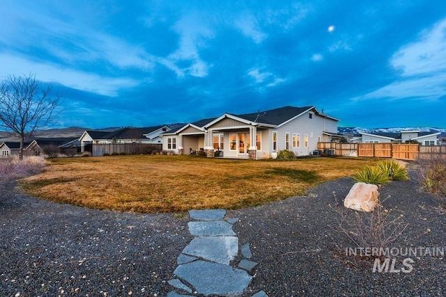 exterior space featuring a front lawn and fence