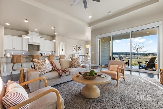 living area featuring a ceiling fan, recessed lighting, wood finished floors, and baseboards