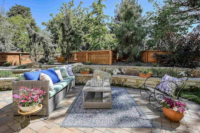 view of patio / terrace featuring an outdoor hangout area and a fenced backyard