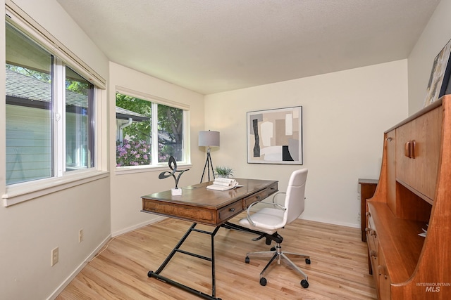 home office with light wood finished floors and baseboards