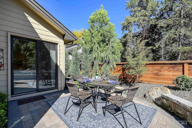 view of patio featuring fence and outdoor dining space