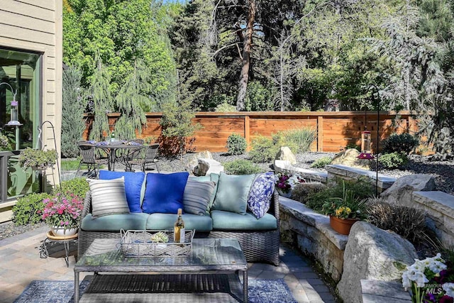 view of patio / terrace with outdoor lounge area, outdoor dining area, and fence