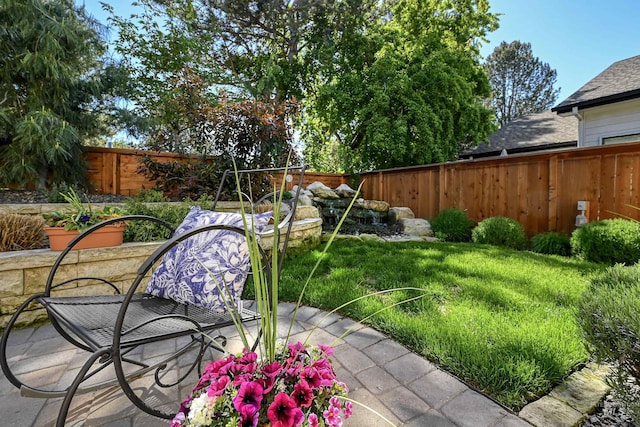 fenced backyard featuring a patio area