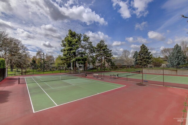 view of tennis court with fence and community basketball court