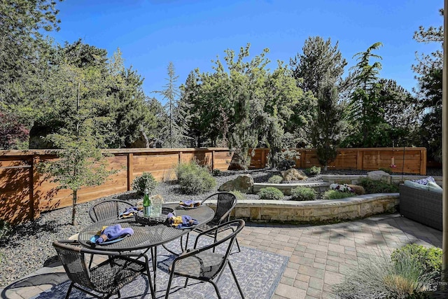 view of patio featuring a fenced backyard and outdoor dining space