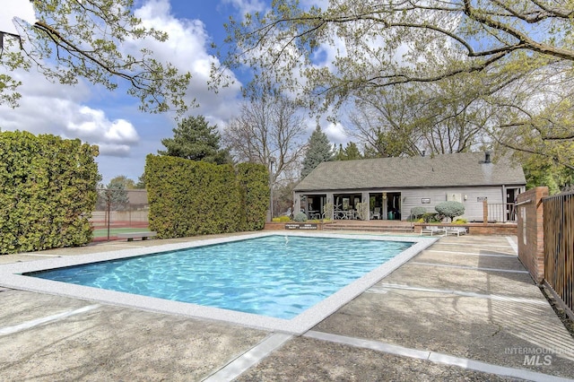 view of pool with a patio area and fence