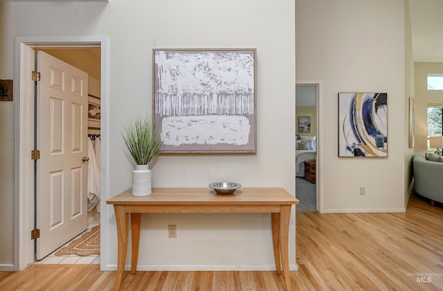 interior space featuring light wood-style floors and baseboards