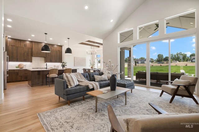 24910 Ardmore Ct, Caldwell, ID 83607 - living room featuring high vaulted ceiling, light wood-style floors, recessed lighting, ceiling fan, and a chandelier