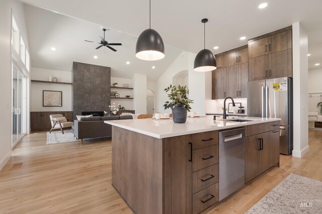 24910 Ardmore Ct, Caldwell, ID 83607 - kitchen with appliances with stainless steel finishes, modern cabinets, a sink, light wood-style flooring, and an island with sink