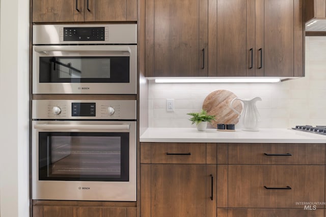24910 Ardmore Ct, Caldwell, ID 83607 - kitchen featuring tasteful backsplash, light countertops, modern cabinets, and double oven