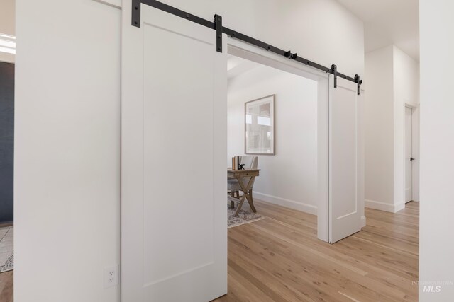 24910 Ardmore Ct, Caldwell, ID 83607 - detailed view of a barn door, baseboards, and wood finished floors