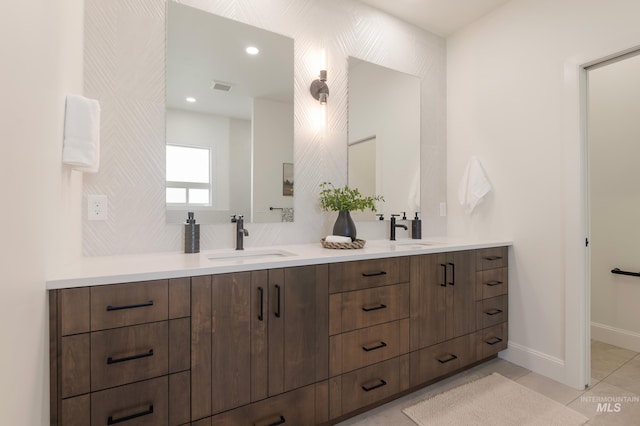 24910 Ardmore Ct, Caldwell, ID 83607 - bathroom featuring double vanity, tile patterned flooring, and baseboards
